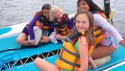 Kids on a boat with life jackets